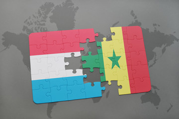puzzle with the national flag of luxembourg and senegal on a world map