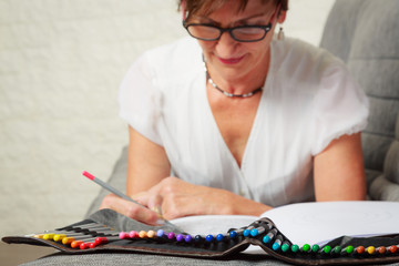 Senior WomanDrawing In Coloring Book