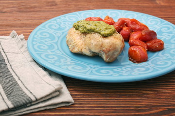 tasty baked chicken breasts covered with basil pesto sauce