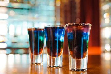 Multicolored shots on the bar