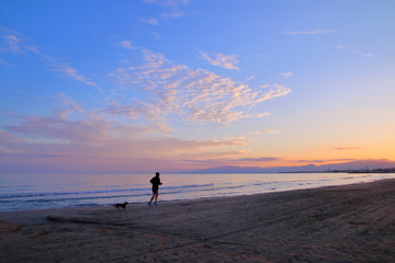 Fototapeta na wymiar Evening jog along the beach.