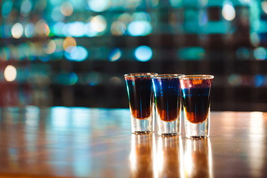 Multicolored shots on the bar