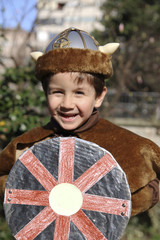 happy little kid with a Viking costume in carnival