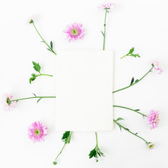 Frame of pink flowers and card on white background. Flat lay, top view. Valentine's background