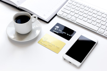 Obraz na płótnie Canvas credit card, keyboard, smartphone and coffee cup on white background