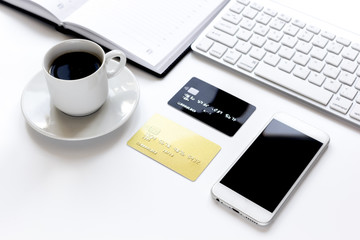 credit card, keyboard, smartphone and coffee cup on white background