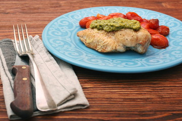 tasty baked chicken breasts covered with basil pesto sauce