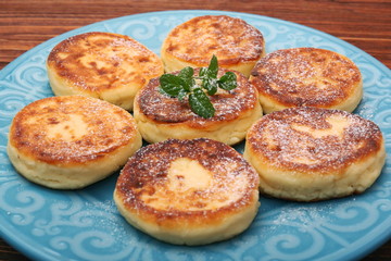 Obraz na płótnie Canvas Cheese pancakes fried in a pan.