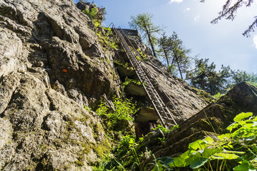Rock climbing route on a cliff in Switzerland with an old metal ladder bolted to the stone