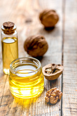 cosmetic and therapeutic walnut oil on wooden background