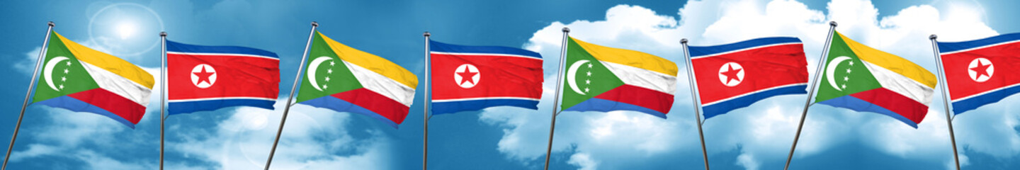Comoros flag with North Korea flag, 3D rendering