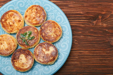 Cheese pancakes fried in a pan.