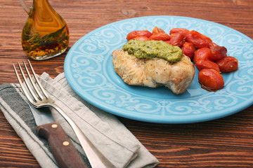 tasty baked chicken breasts covered with basil pesto sauce
