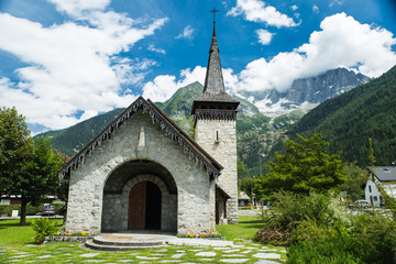 Old stone church under the peaks of the French alps in Chamonix