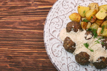 Fototapeta na wymiar Beef meatballs with potatoes and creamy gravy