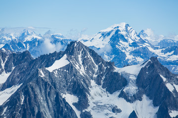 Ice, snow, and glaciers cling to the sides of Mont Blanc in the french Alps