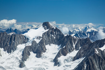 Fototapeta na wymiar Ice, snow, and glaciers cling to the sides of Mont Blanc in the french Alps