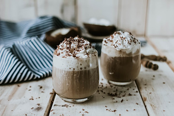 mug of hot chocolate cocoa with whipped cream, slice of bitter chocolate