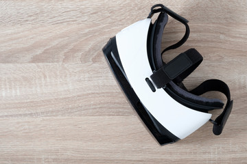 Top view VR virtual reality glasses  on wooden table