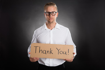 Man Holding Cardboard With Thank You Text Written On It