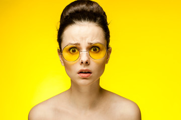 stunned woman in yellow glasses