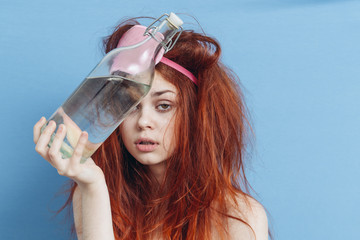 woman with disheveled hair and bottle near the head