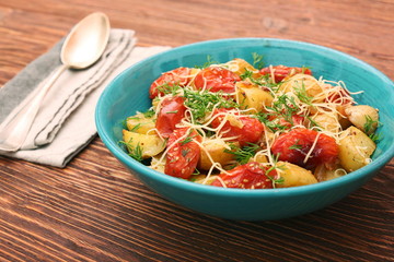 Fried potato and tomato salad with cheese