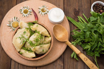 Dumplings with the liver. Wooden background. Top view