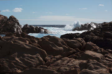 Waves Crash on ocean rocks 