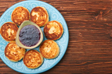 Cheese pancakes fried in a pan.