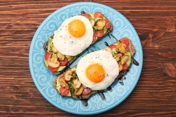 Fototapeta na wymiar Sandwich with egg, tomato, greens, and mushrooms
