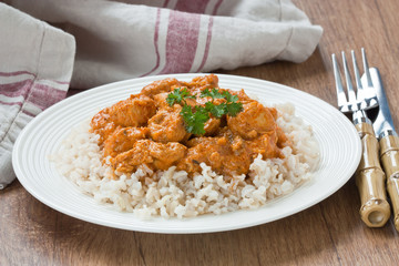 Chicken curry sauce / Chicken curry with brown rice in white plate on wooden background