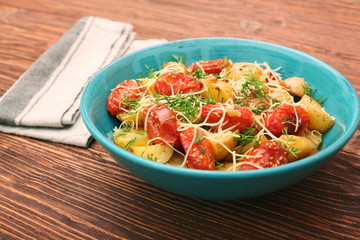 Fried potato and tomato salad with cheese