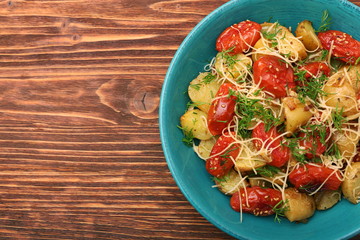 Fried potato and tomato salad with cheese