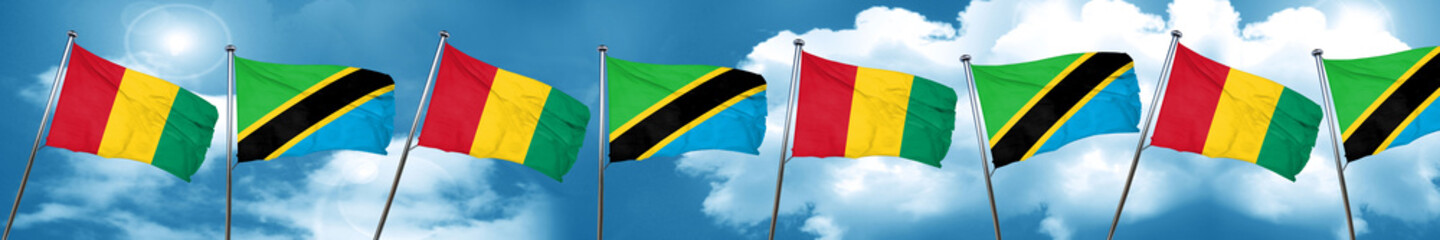 Guinea flag with Tanzania flag, 3D rendering