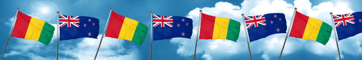 Guinea flag with New Zealand flag, 3D rendering