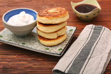 Cheese pancakes fried in a pan.