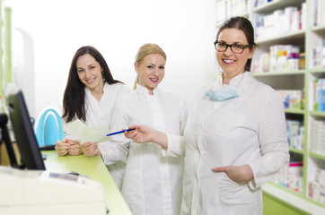 Obraz premium Three female pharmacist smiling and looking at camera, selective focus on blonde woman 