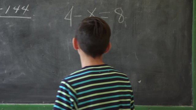 Young people and education. Group of hispanic students in class at school during lesson. Portrait of happy latino boy, hispanic student smiling at camera