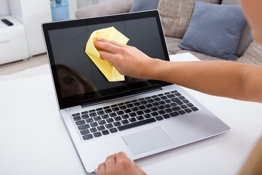 Woman Hand Cleaning Laptop Screen