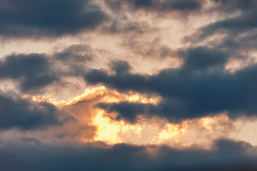 Celestial Battle. Cloud in the form of a crocodile absorbs light at sunset enemy.