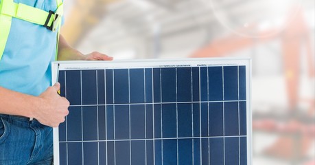 Construction worker standing with solar panel - Powered by Adobe