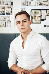 Portrait of a smart young man standing with arms crossed