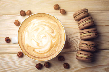 Flavored coffee cappuccino with macarons and nuts. The perfect Breakfast