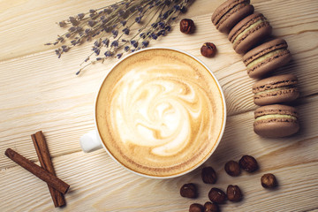 Flavored coffee cappuccino with macarons and nuts. The perfect Breakfast