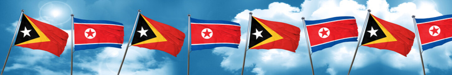 east timor flag with North Korea flag, 3D rendering