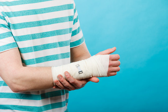 Man with painful bandaged hand.