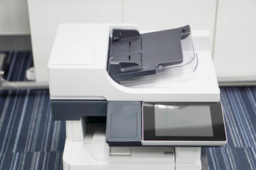 modern printer is placed in office ready for printing and scanning documents