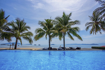 Obraz na płótnie Canvas Tropical resort swimming pool and beautiful seascape