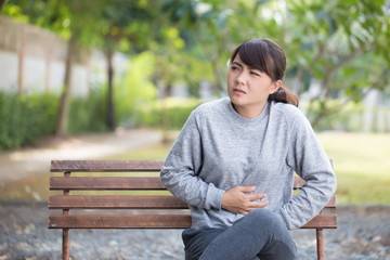 Woman has stomachache at park